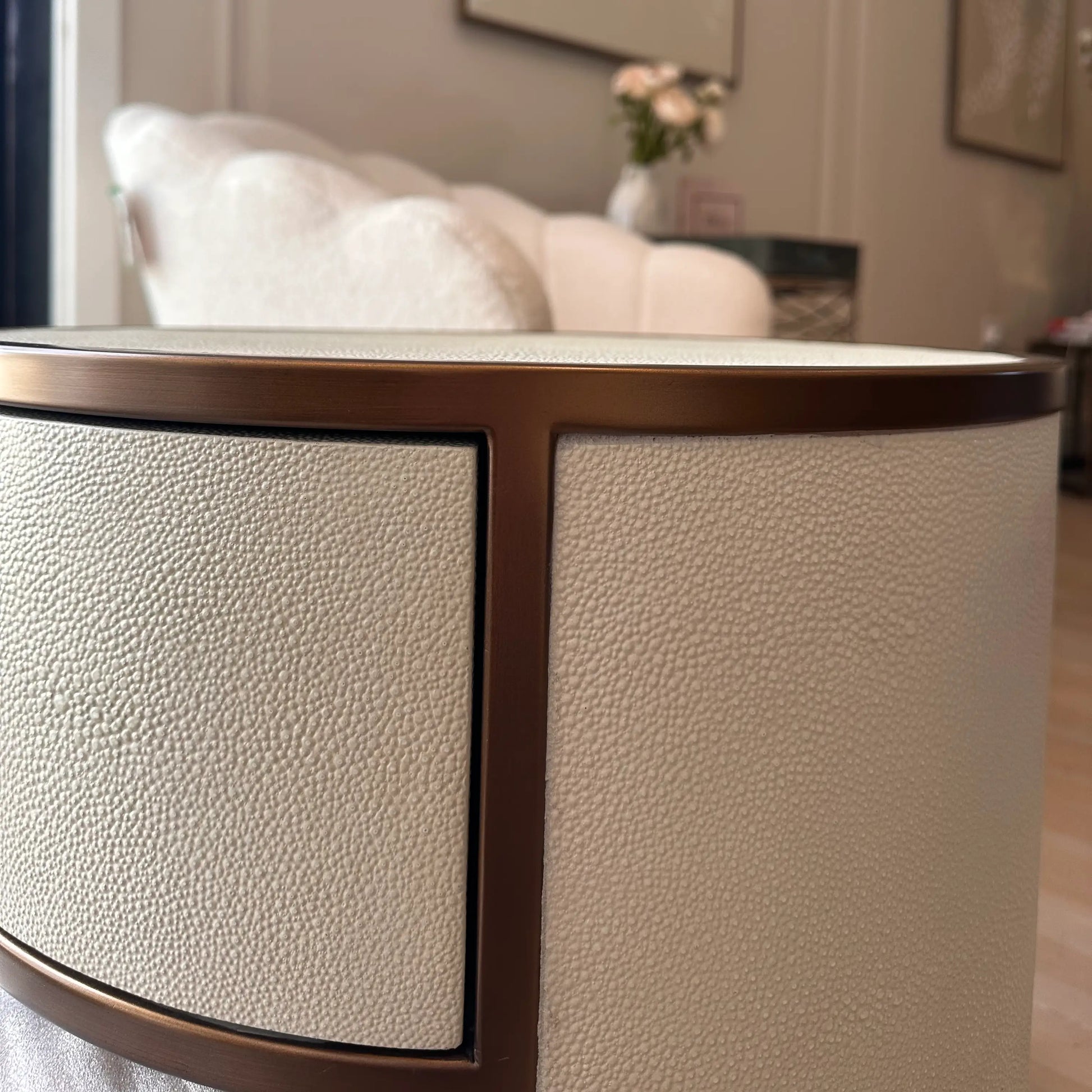 faux-ivory-shagreen-fabric-bedside-tables-ound-in-shape-with-antique-brass-metal-frame-and-legs-with-single-drawer-and-shelf-interior-design-essentials-at-albury-house-interiors