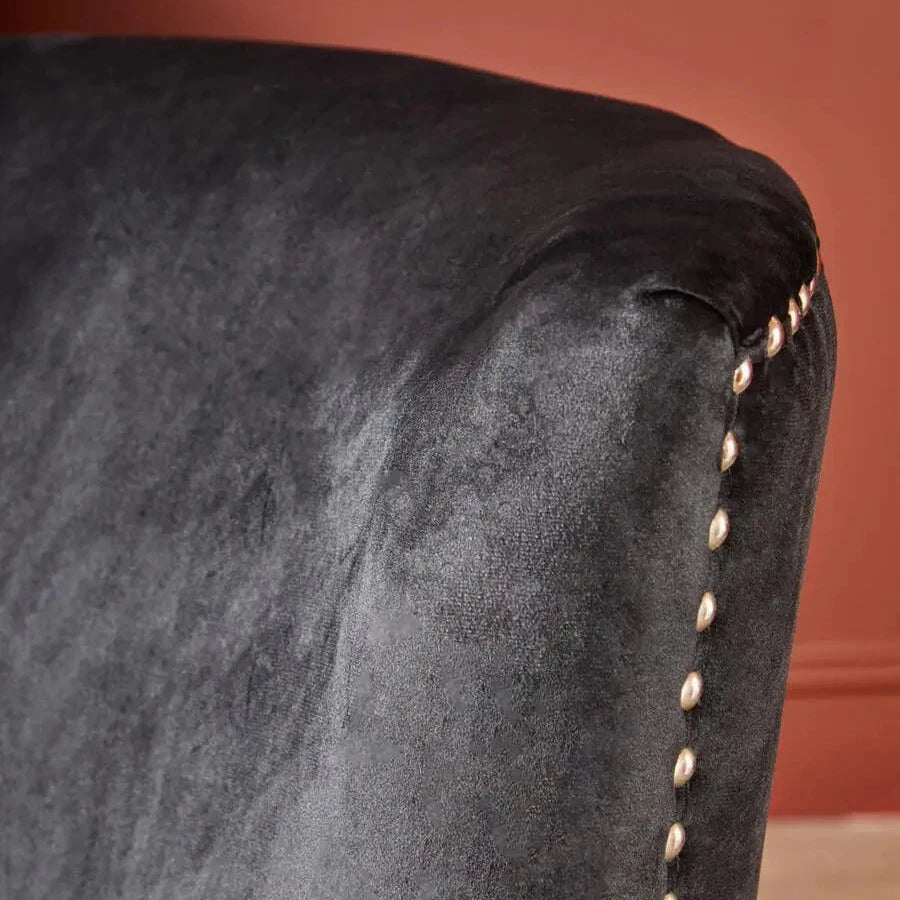 Cologne black soft velvet occasional chair with matching black wooden square legs and silver studded detail around front and back edges. Available at Albury House Interiors