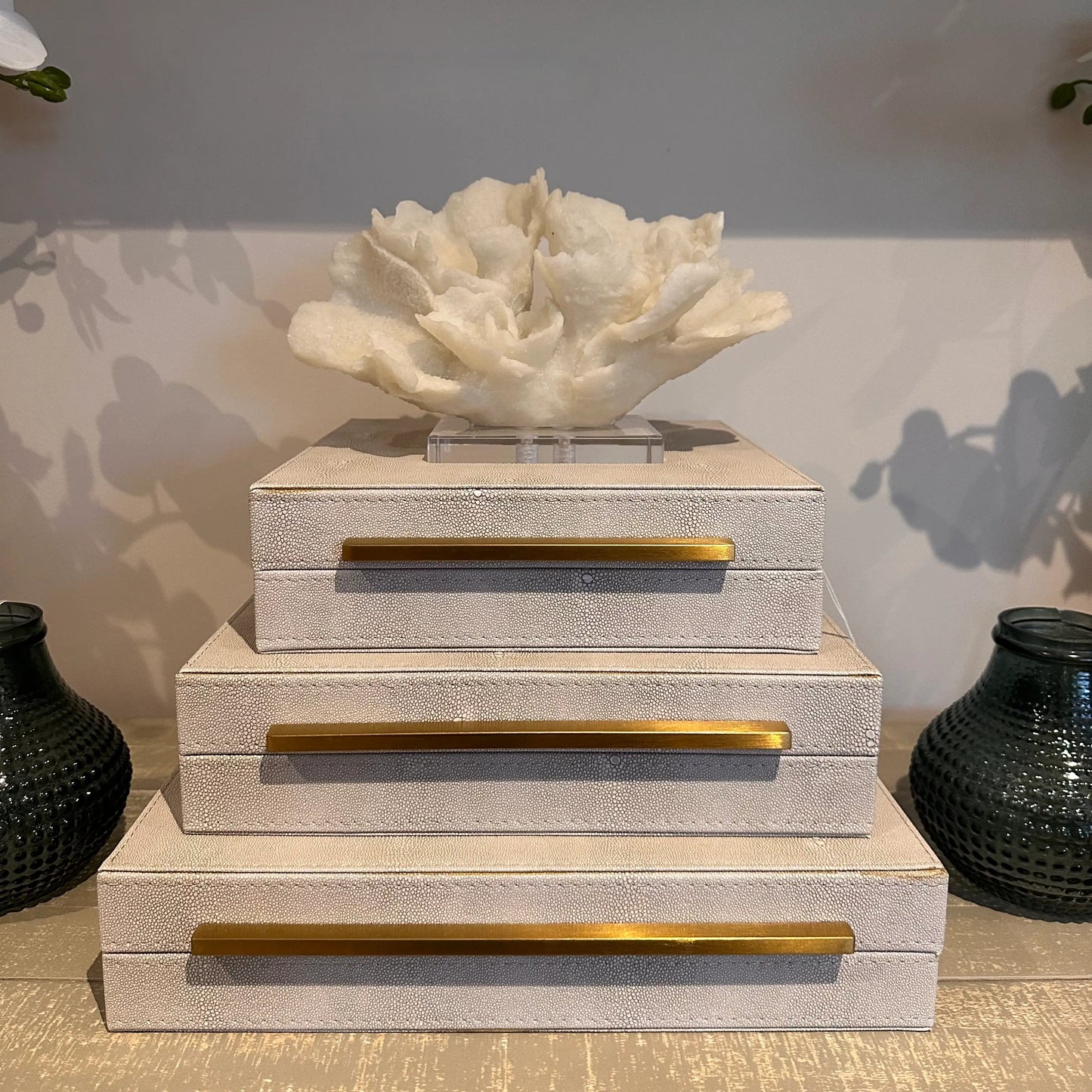 cream-faux-coral-sculpture-on-clear-acrylic-base-on-top-of-cream-faux-shagreen-boxes-at-albury-house-interiors