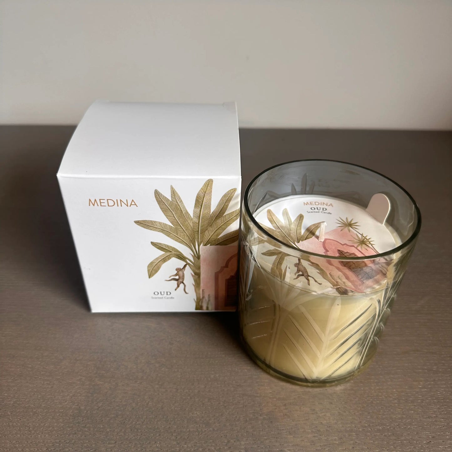 Medina candle in an engraved glass jar with decorative palm tree design, our scented, gift boxed in a white box with a monkey on the front. Available to purchase at Albury House Interiors, Essex. 