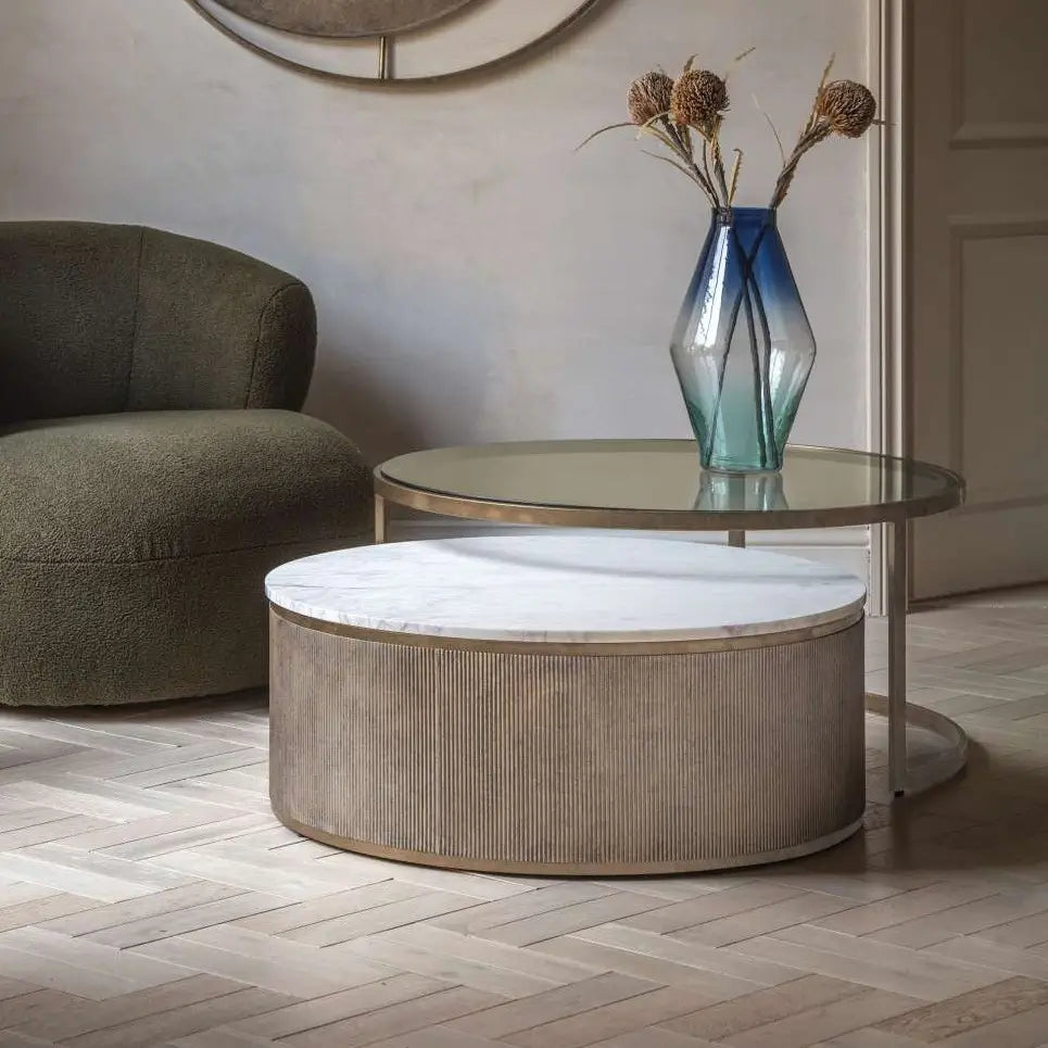 Set of two nesting coffee tables crafted from brushed bronze with smoked glass and white natural marble tops. As used by interior designers across the UK. Available to purchase from Albury House Interiors, Matching Tye Essex. 