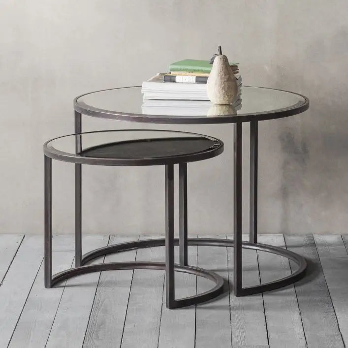 Drea round nest of coffee tables set, iron frames finished in antique bronze with glass mirror tops at Albury House Interiors.