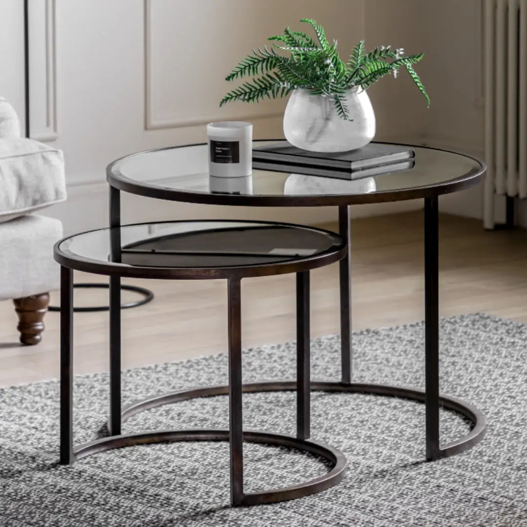 Drea round nest of coffee tables set, iron frames finished in antique bronze with glass mirror tops at Albury House Interiors.