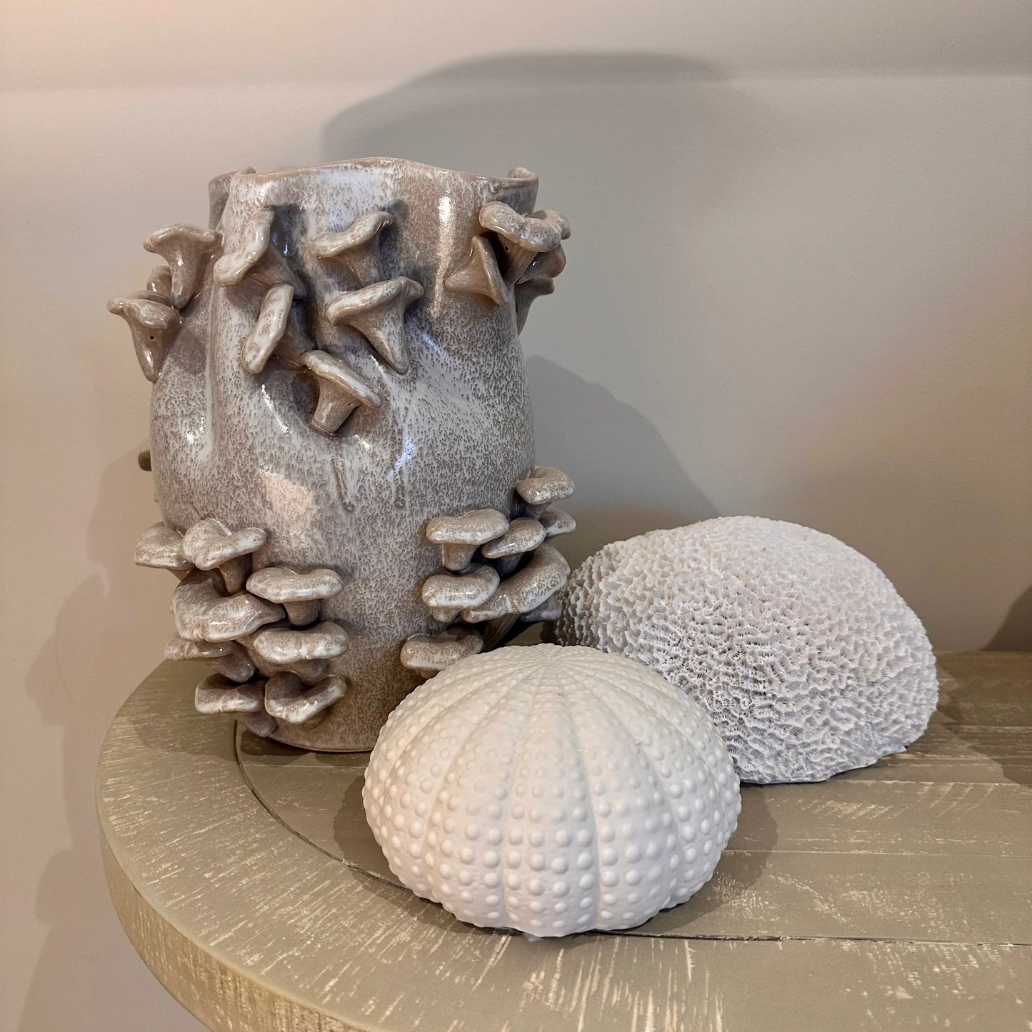 taupe-and-white-speckled-flecked-mushroom-fungi-vase-on-sideboard-with-faux-ceramic-urchin-ornament-and-faux-sea-coral-at-albury-house-interiors-homewares-giftware-shop-essex
