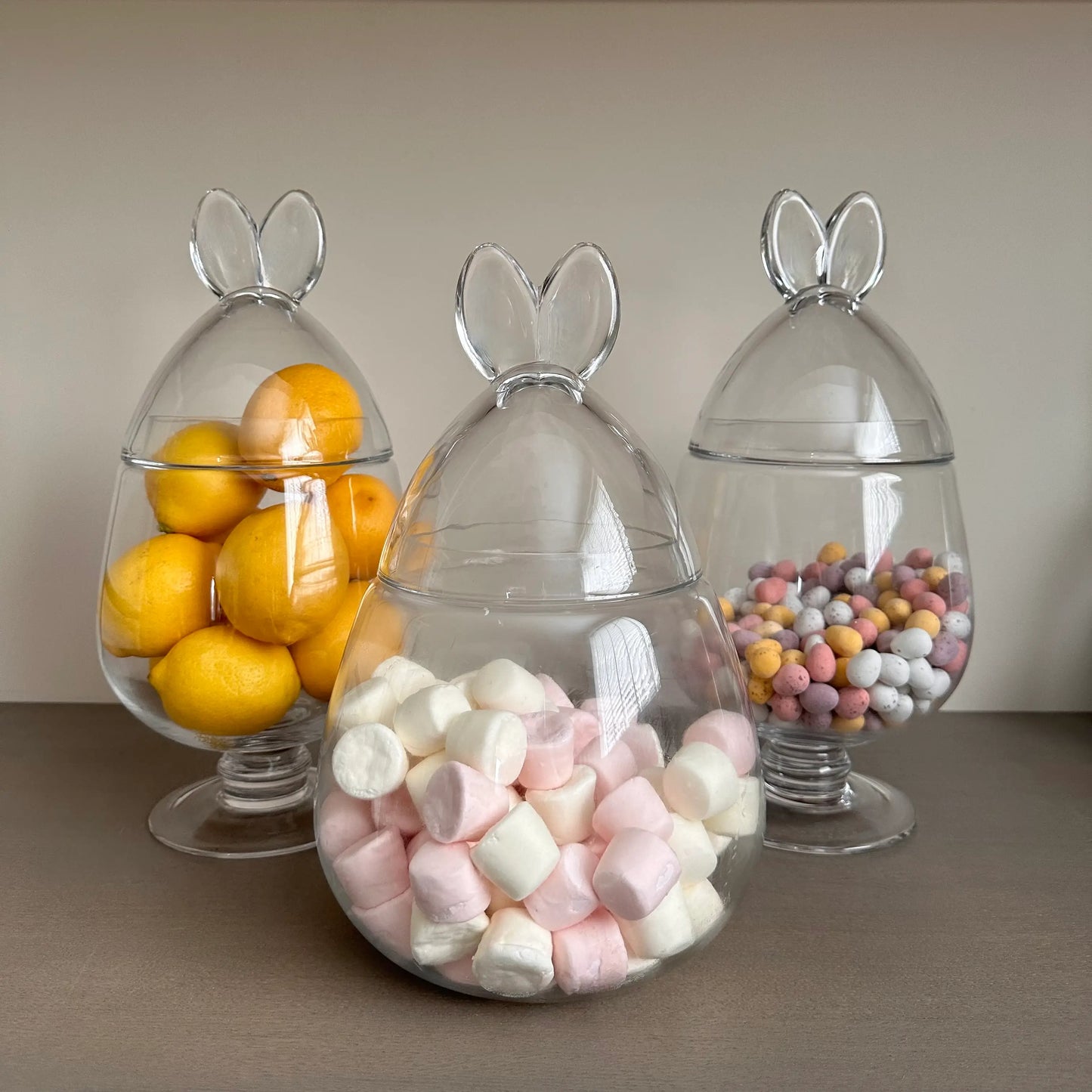 collection-of-glass-bunny-ear-ginger-jars-with-mini-eggs-marshmallows-and-lemons-at-albury-house-interiors