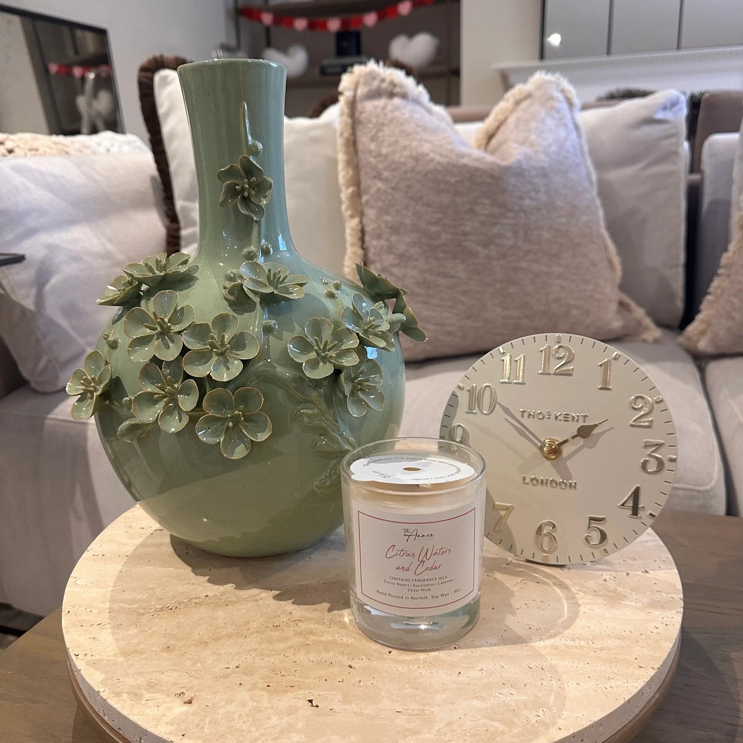 sage-green-ceramic-blossom-vase-with-3d-flowers-on-terrazzo-stone-tray-with-ball-feet-and-small-cream-mantel-clock-at-albury-house-interiors