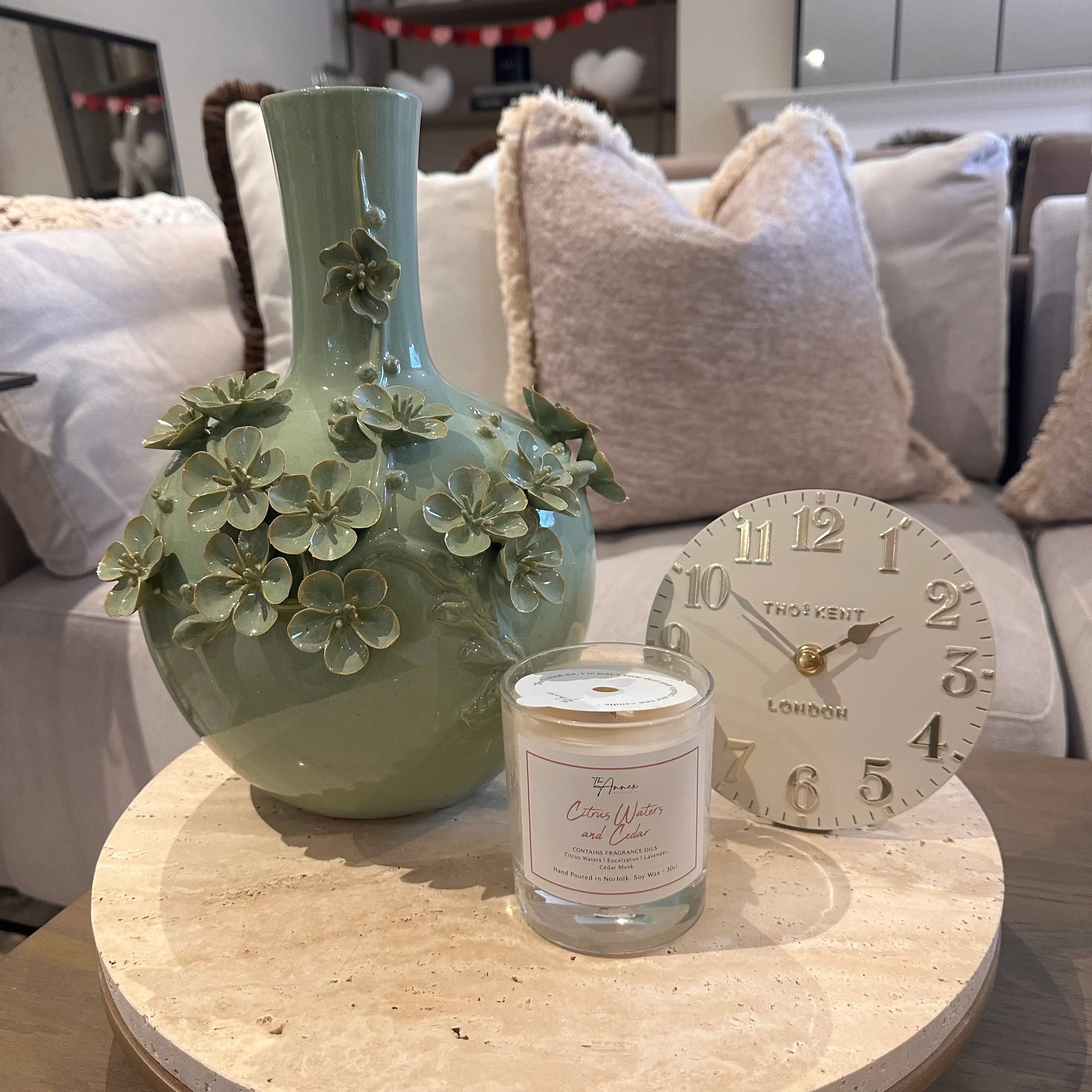 sage-green-ceramic-blossom-vase-with-3d-flowers-on-terrazzo-stone-tray-with-ball-feet-and-small-cream-mantel-clock-at-albury-house-interiors