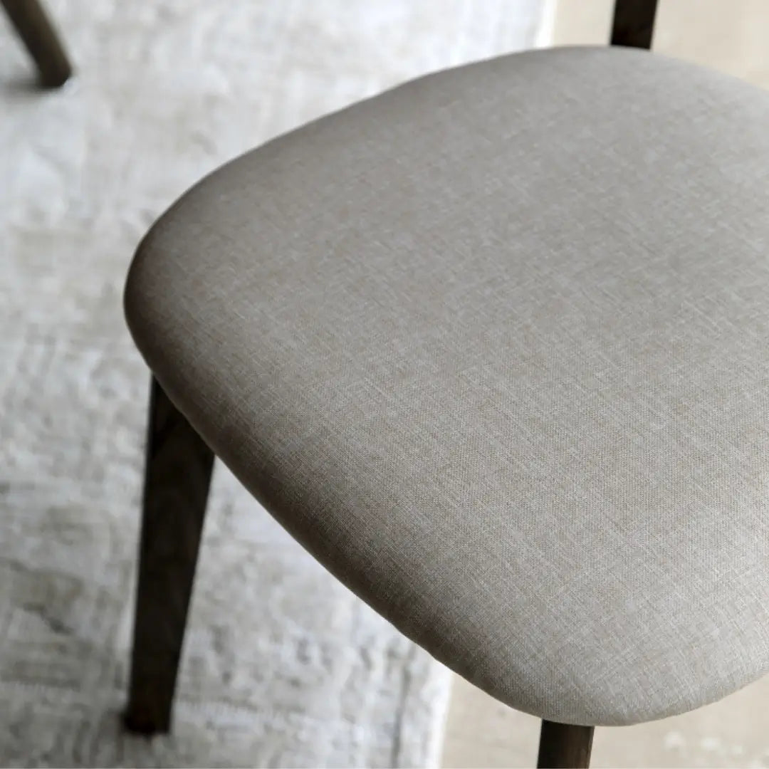 Haze dark wooden veneer dining chairs with linen cushioned seat and back rest. Available to purchase at Albury House Interiors. 