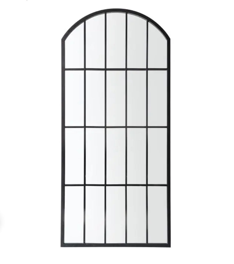 An arched industrial-style mirror with a black metal frame and grid pattern, shown against a plain white background. Available at Albury House Interiors