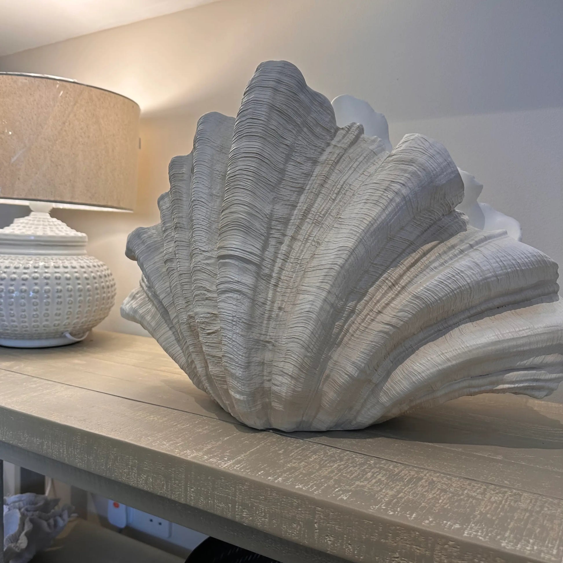 extra-large-clam-shell-vase-ornament-in-neutral-colours-with-cream-white-ceramic-dimple-lamp-at-albury-house-interiors-showroom-essex