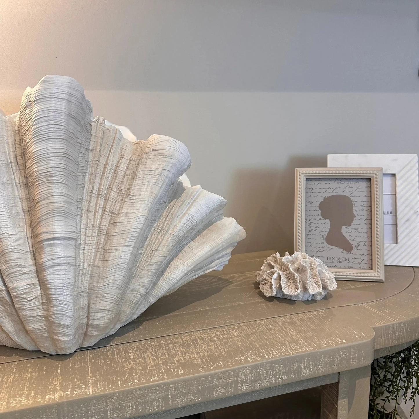 large-resin-clam-shell-vase-ornament-with-small-faux-coral-and-beaded-photoframe-at-albury-house-interiors-showroom