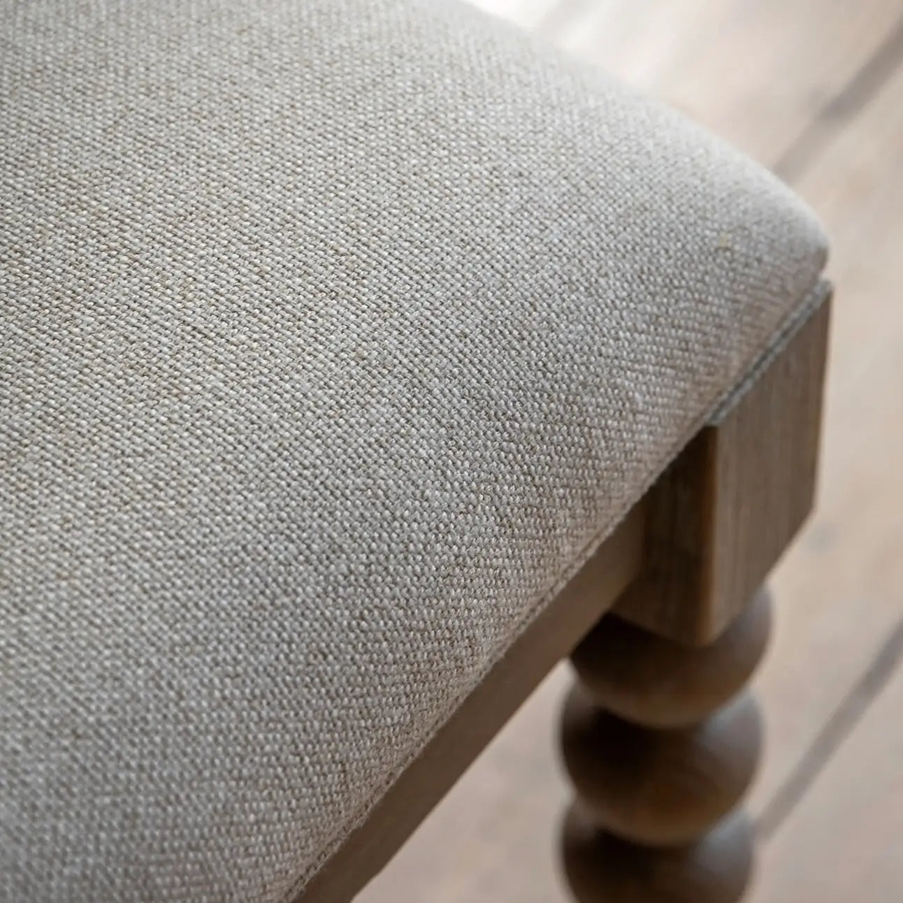lime-washed-oak-dining-bench-bobbin-round-detailed-legs-with-biscuit-neutral-fabric-upholstery-at-albury-house-interiors-giftware-and-homeware-shop-in-essex
