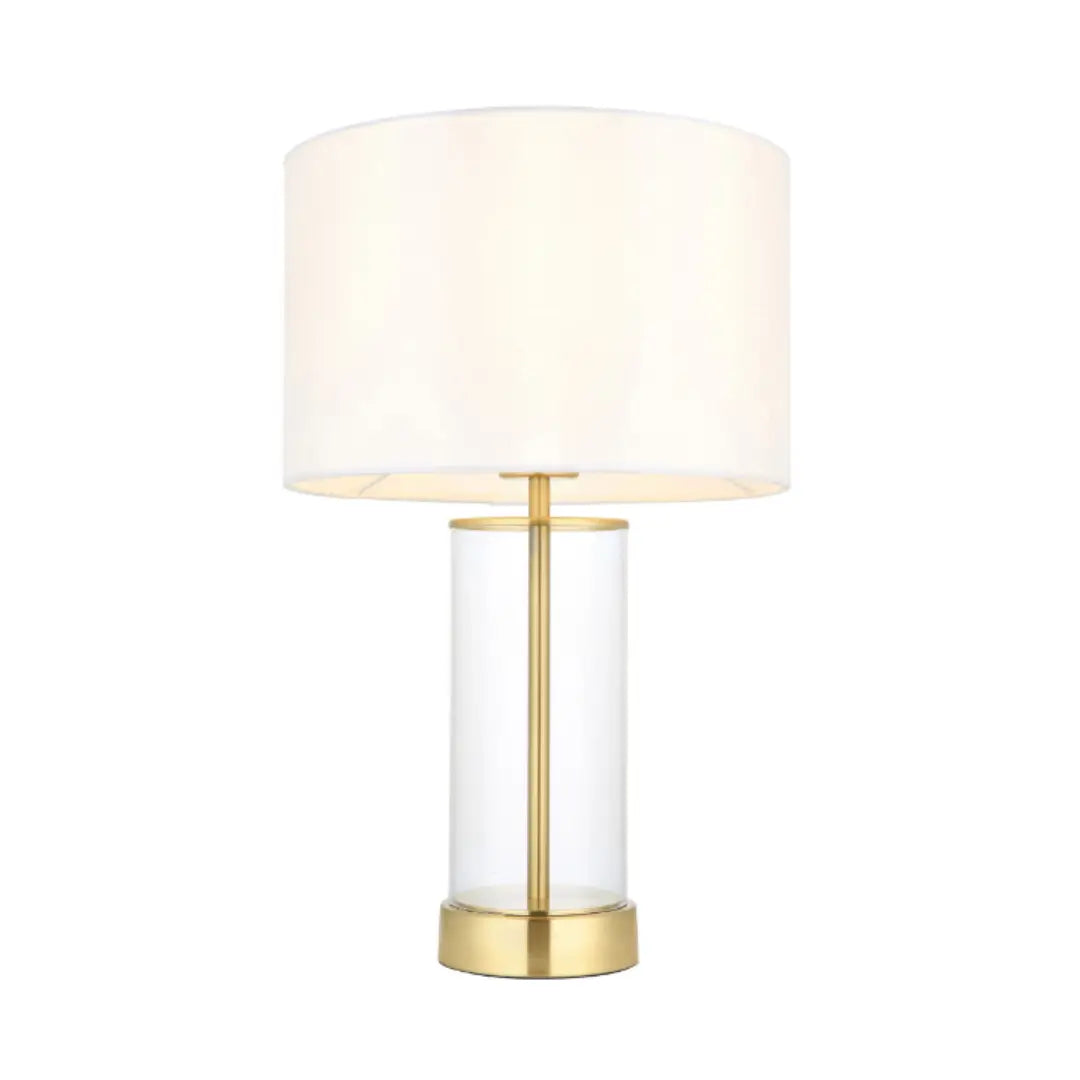 Louvre glass cylinder table lamp with brushed gold accents, complete with white faux silk round lampshade, available at Albury House Interiors, homewares shop in Essex. 
