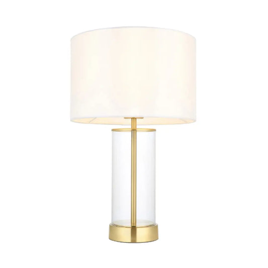 Louvre glass cylinder table lamp with brushed gold accents, complete with white faux silk round lampshade, available at Albury House Interiors, homewares shop in Essex. 