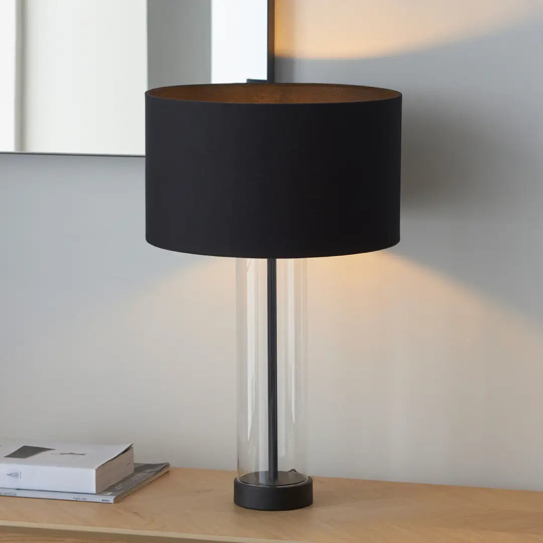Louvre matt black iron and grass cylindrical table lamp, with matching black round shade. Perfect for living areas, bedrooms, dining rooms and entrance halls. Available in black and gold, from Albury House Interiors. 