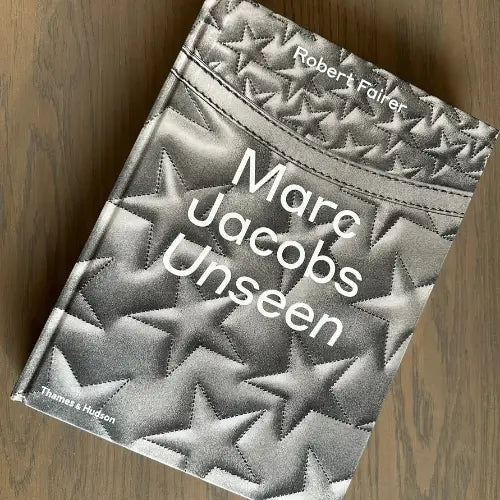 Silver grey Marc Jacobs Unseen hardback coffee table book, with stars on the front cover, back and spine. Available to purchase from Albury House Interiors.