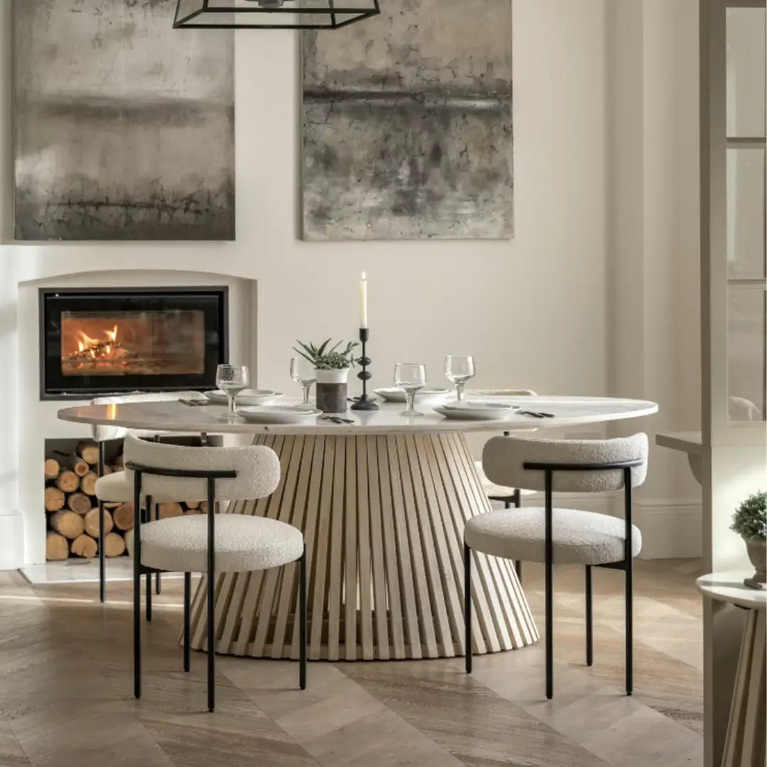Mayfair oval shaped dining table with natural white veined marble top and whitewashed mango wood base, sandblasted for effect. Paired with Ava boucle dining chairs in vanilla colour with matte black frames and legs. Can sit 4-6 people. Whole range available to purchase from Albury House Interiors. 