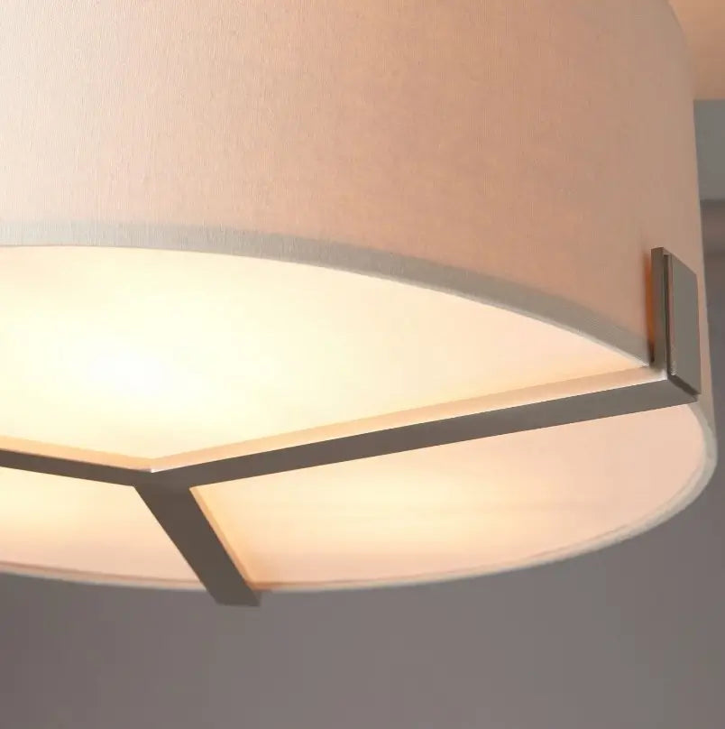 Minnesota round ceiling light with a brushed nickel finish, featuring three lightbulbs and a neutral-colored linen-effect lampshade. Available for purchase at Albury House Interiors.