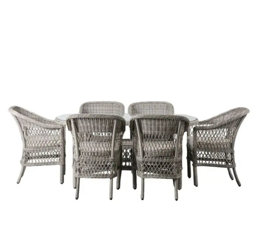 Moreton stone grey colour rattan outdoor furniture, 6 chairs and a glass topped oval dining table with showerproof seat and back cushions, available at Albury House Interiors