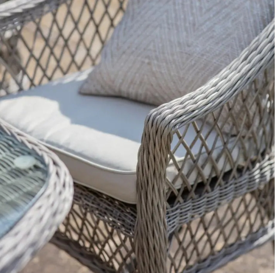 Moreton stone grey colour rattan outdoor furniture, 6 chairs and a glass topped oval dining table with showerproof seat and back cushions, available at Albury House Interiors