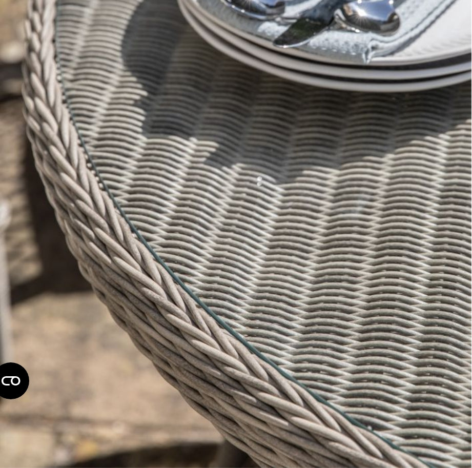Moreton stone grey colour rattan outdoor furniture, 6 chairs and a glass topped round dining table with showerproof seat and back cushions, available at Albury House Interiors