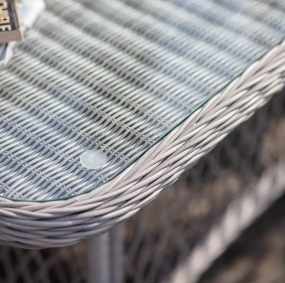 Close-up of a woven chair with a textured surface. Moreton stone grey colour rattan outdoor furniture, 3-seater sofa, two armchairs and a dining table with showerproof seat and back cushions, available at Albury House Interiors