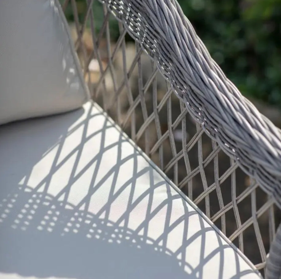 Close-up of a textured surface with a geometric pattern, Moreton stone grey colour rattan outdoor furniture, 3-seater sofa, two armchairs and a dining table with showerproof seat and back cushions, available at Albury House Interiors