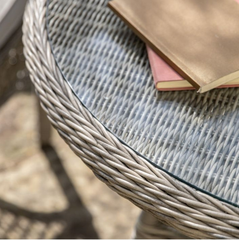 Moreton stone grey colour rattan outdoor furniture, 6 chairs and a glass topped round dining table with showerproof seat and back cushions, available at Albury House Interiors