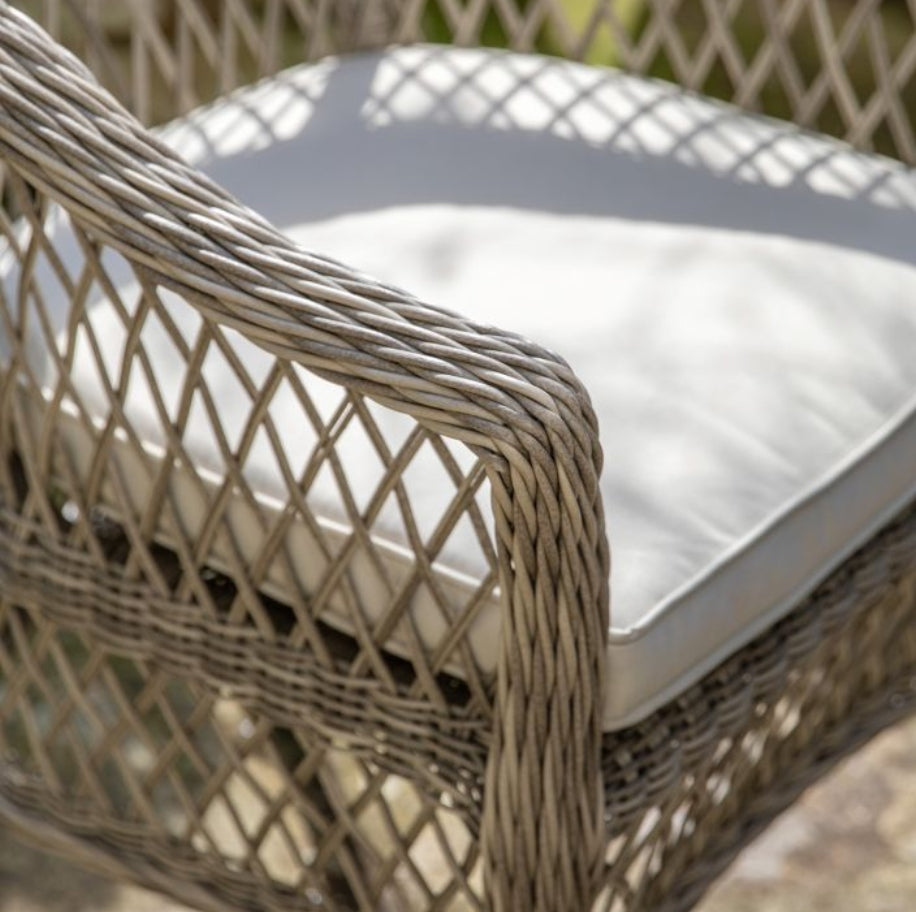 Moreton stone grey colour rattan outdoor furniture, 6 chairs and a glass topped round dining table with showerproof seat and back cushions, available at Albury House Interiors