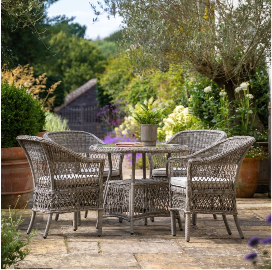Moreton stone grey colour rattan outdoor furniture, 6 chairs and a glass topped round dining table with showerproof seat and back cushions, available at Albury House Interiors