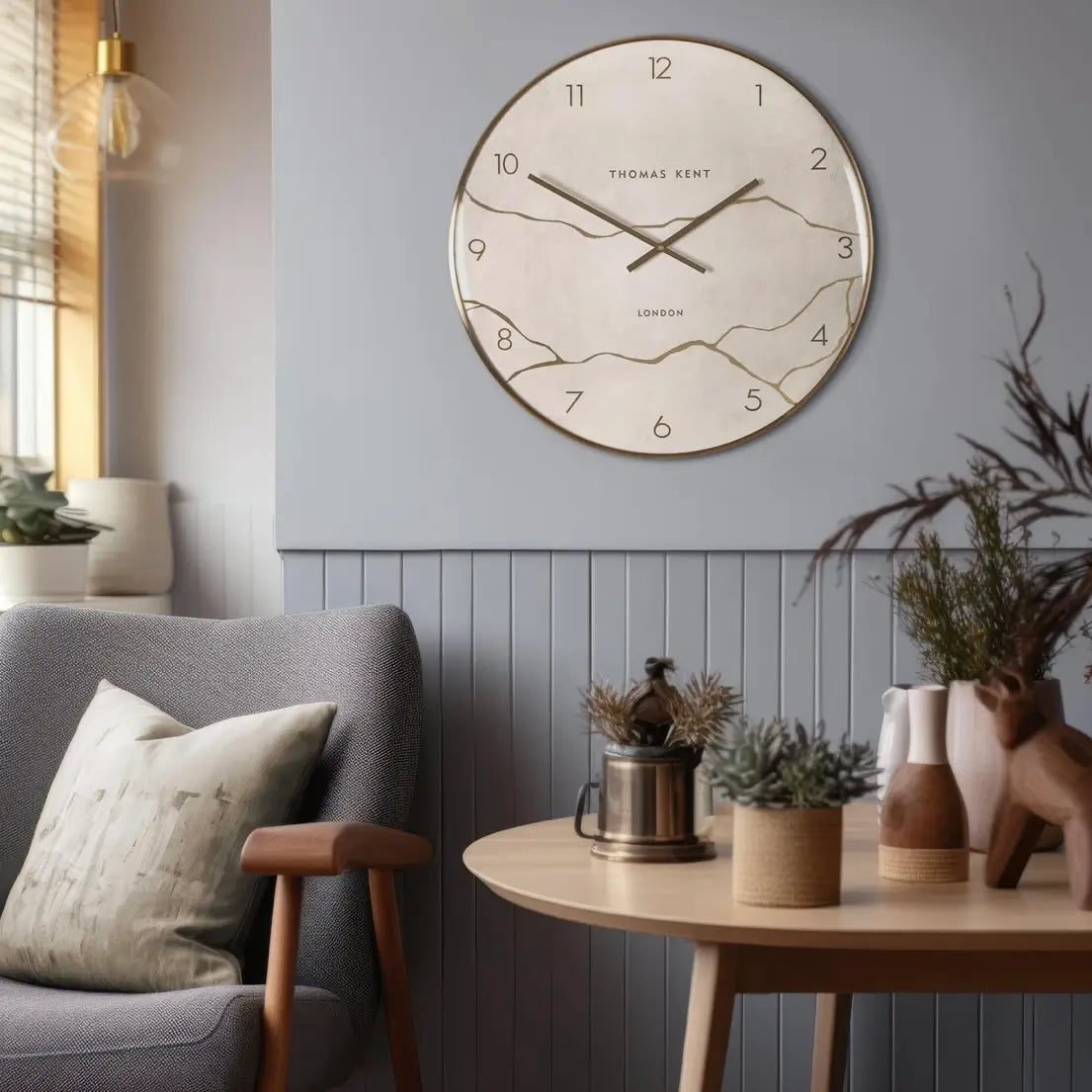 Naples round wall clock crafted by Thomas Kent, inspired by Japanese Kintsugi of fixing ceramics that have been broken. A faux stone clock face with gold veined detailing with matching hands and rim. Available to purchase at Albury House Interiors Essex.