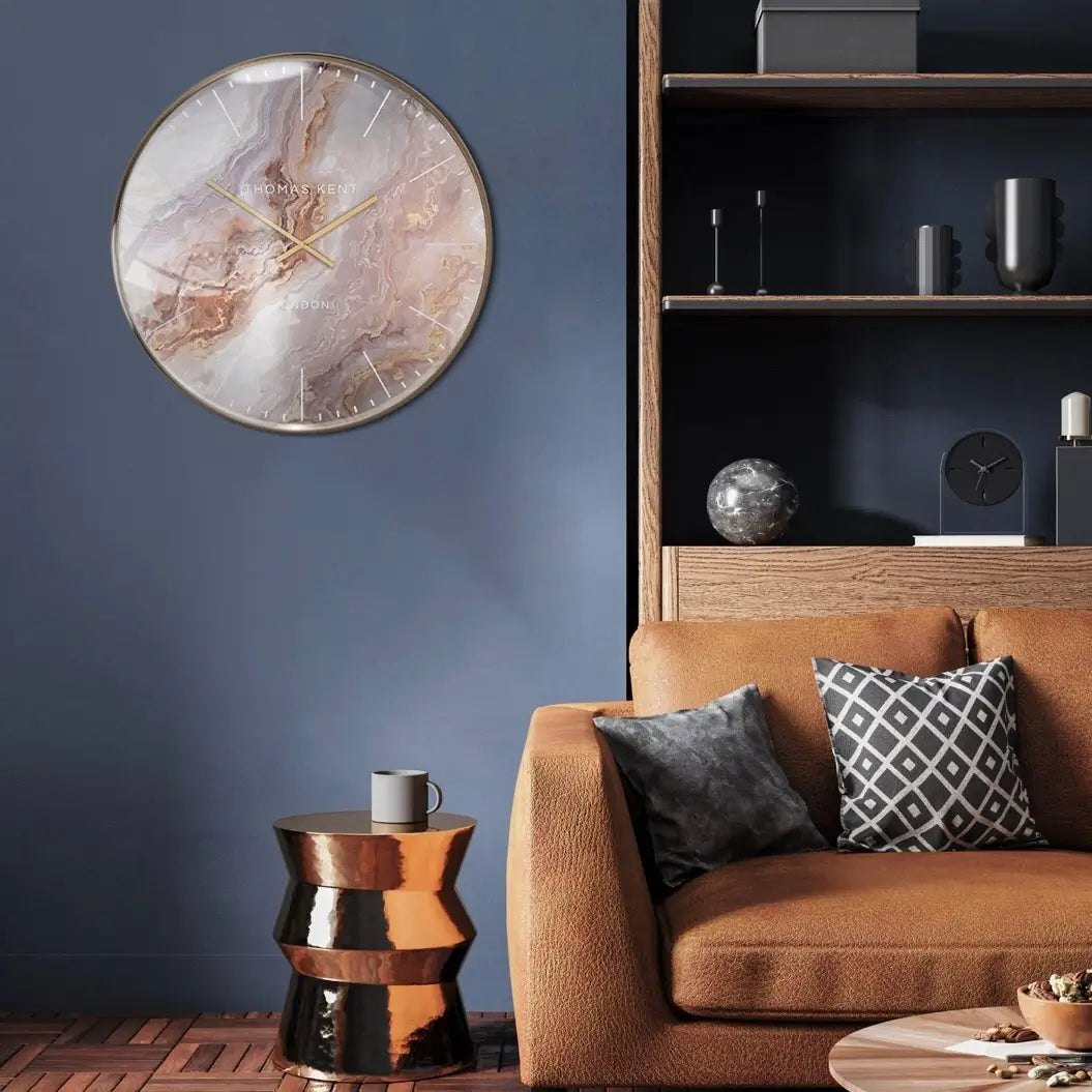 Naples abstract marble effect round wall clock, with swirls of brown, neutral and gold, finished with a gold foil rim and matching hands. Available to purchase at Albury House Interiors.