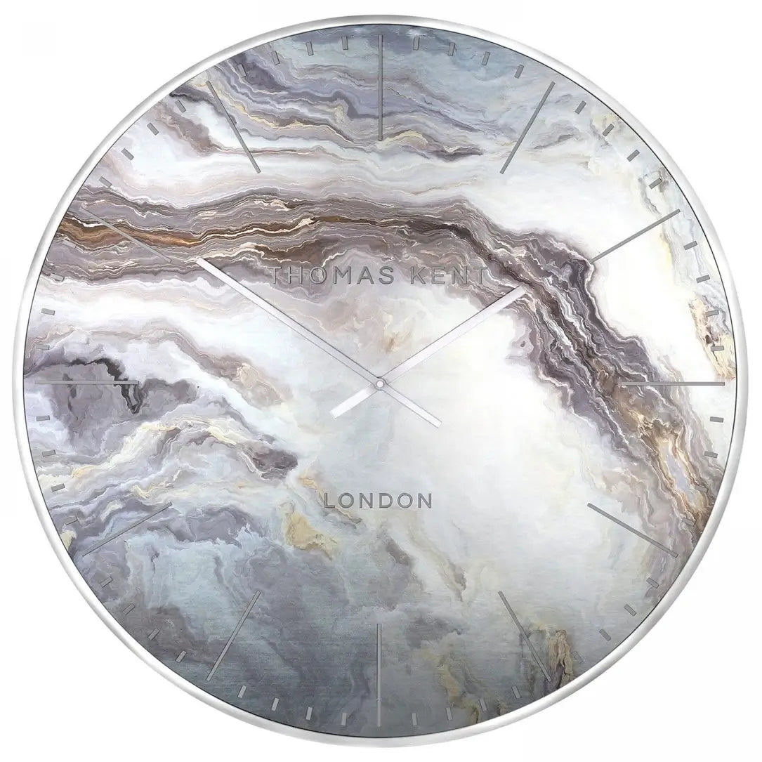 Naples round wall clock inspired by mother of pearl, featuring white, silver, bronze and steel blue swirls giving a marble effect. Finished with a chrome silver rim and matching clock hands, available to purchase at Albury House Interiors.