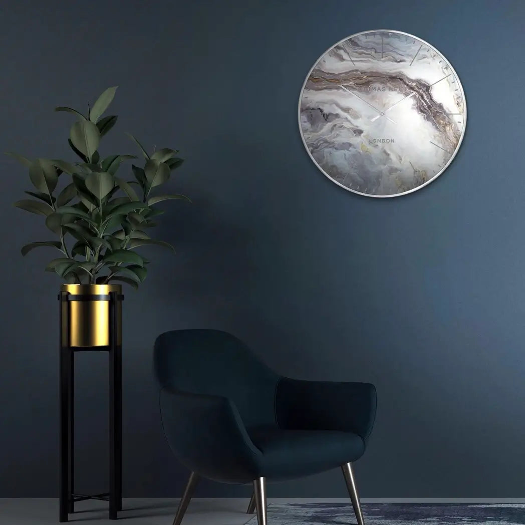 Naples round wall clock inspired by mother of pearl, featuring white, silver, bronze and steel blue swirls giving a marble effect. Finished with a chrome silver rim and matching clock hands, available to purchase at Albury House Interiors.