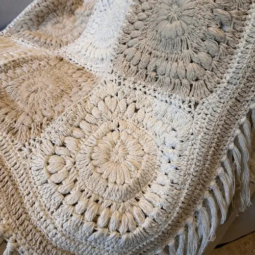 Beautiful white and natural coloured crochet throw blanket, crafted from 100% cotton in India. Complete with fringed tassel edge all the way round. Available at Albury House Interiors. 