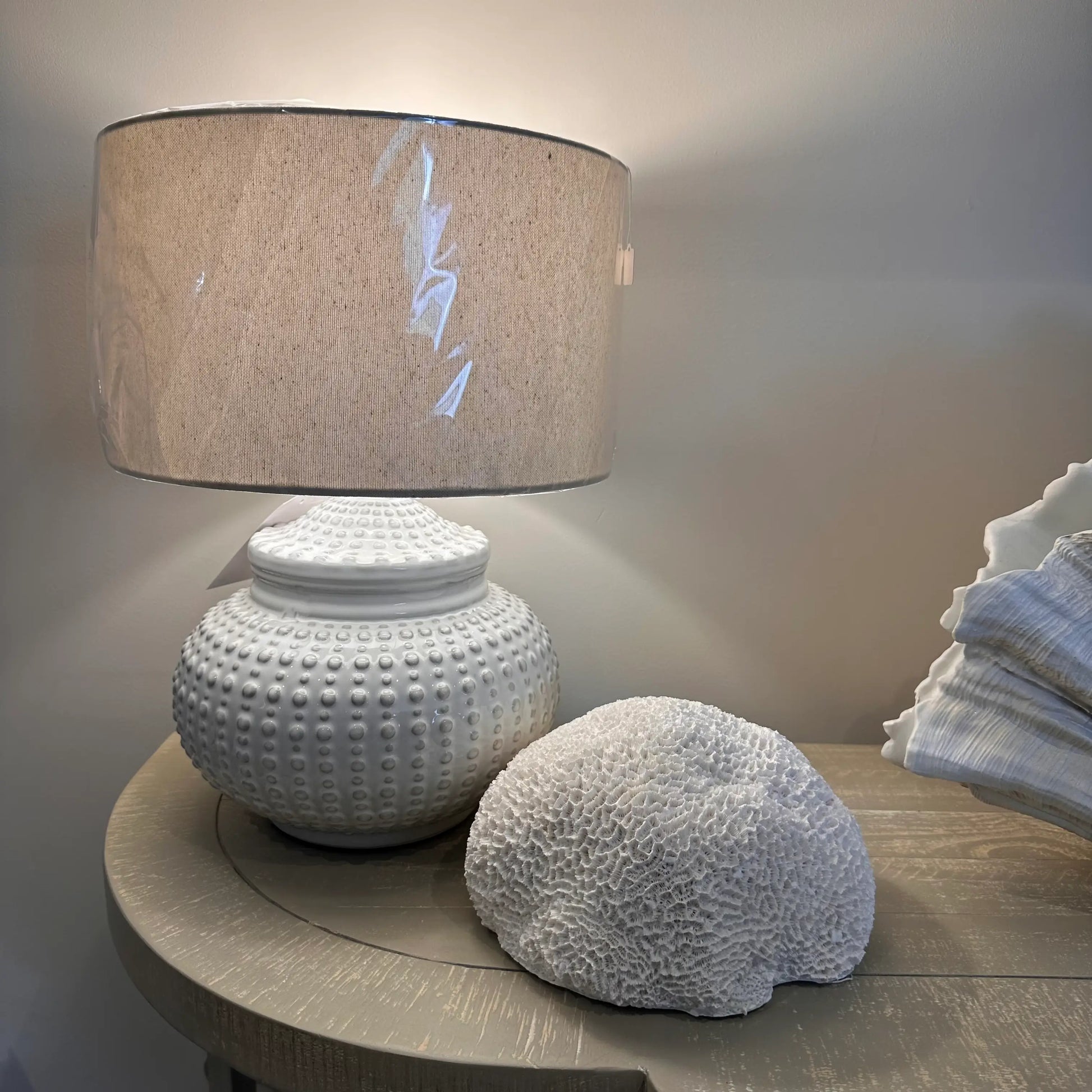 white-ceramic-dimple-squat-lamp-with-linen-shade-textured-nerina-faux-coral-at-albury-house-interiors