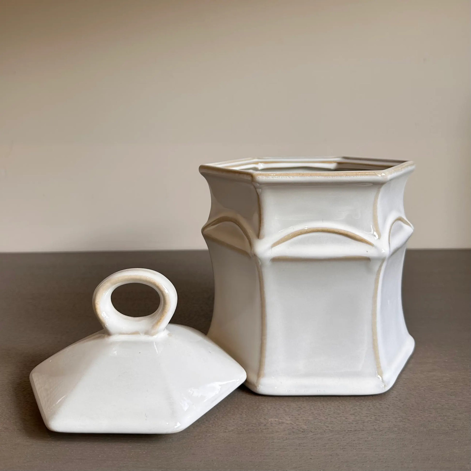 Crafted from neutral coloured ceramic with rustic details, this small jar comes complete with a lid and is perfect for storing all sorts of things in your home. Available to purchase at Albury House Interiors.