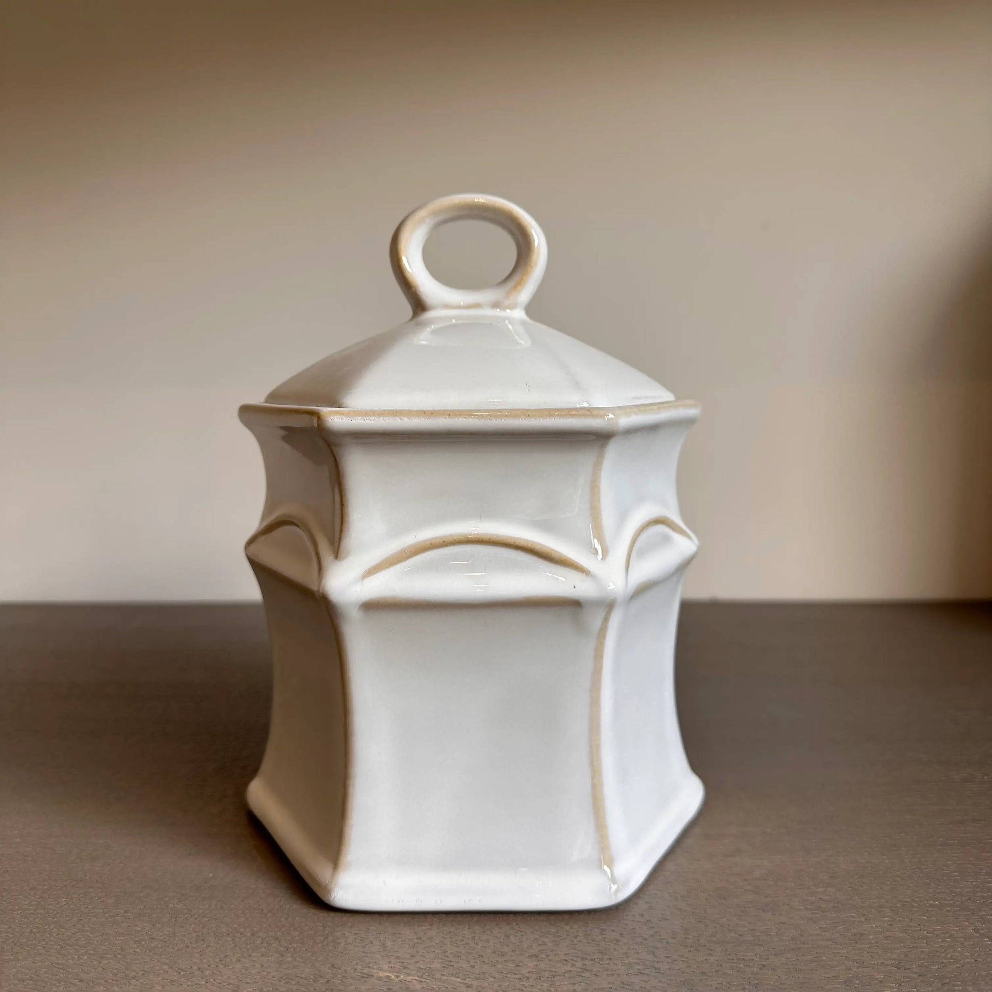 Crafted from neutral coloured ceramic with rustic details, this small jar comes complete with a lid and is perfect for storing all sorts of things in your home. Available to purchase at Albury House Interiors.