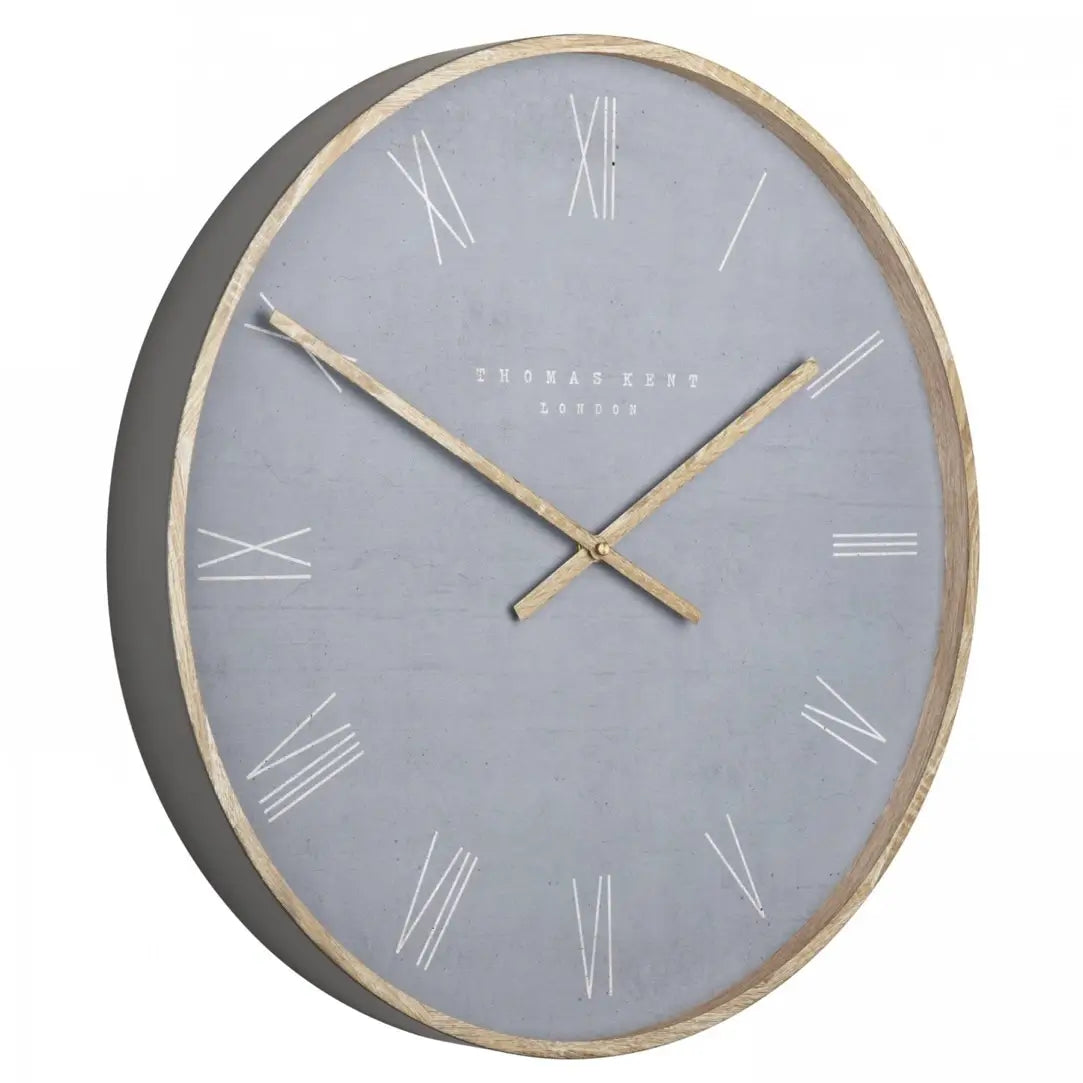 Norway round wall clock in cement grey with wooden effect hands and front rim and roman numeral numbers. Available to purchase at Albury House Interiors.
