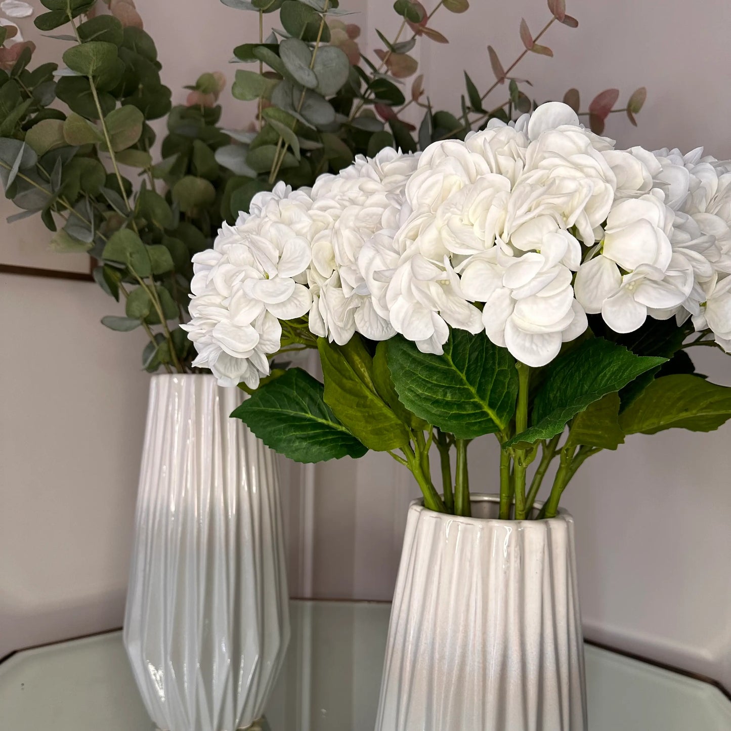Ombre grey and white dipped effect vases in sizes small and large with abstract detail all over, showcasing faux white hydrangeas and eucalyptus. Available to purchase at Albury House Interiors, Matching Tye Essex. 