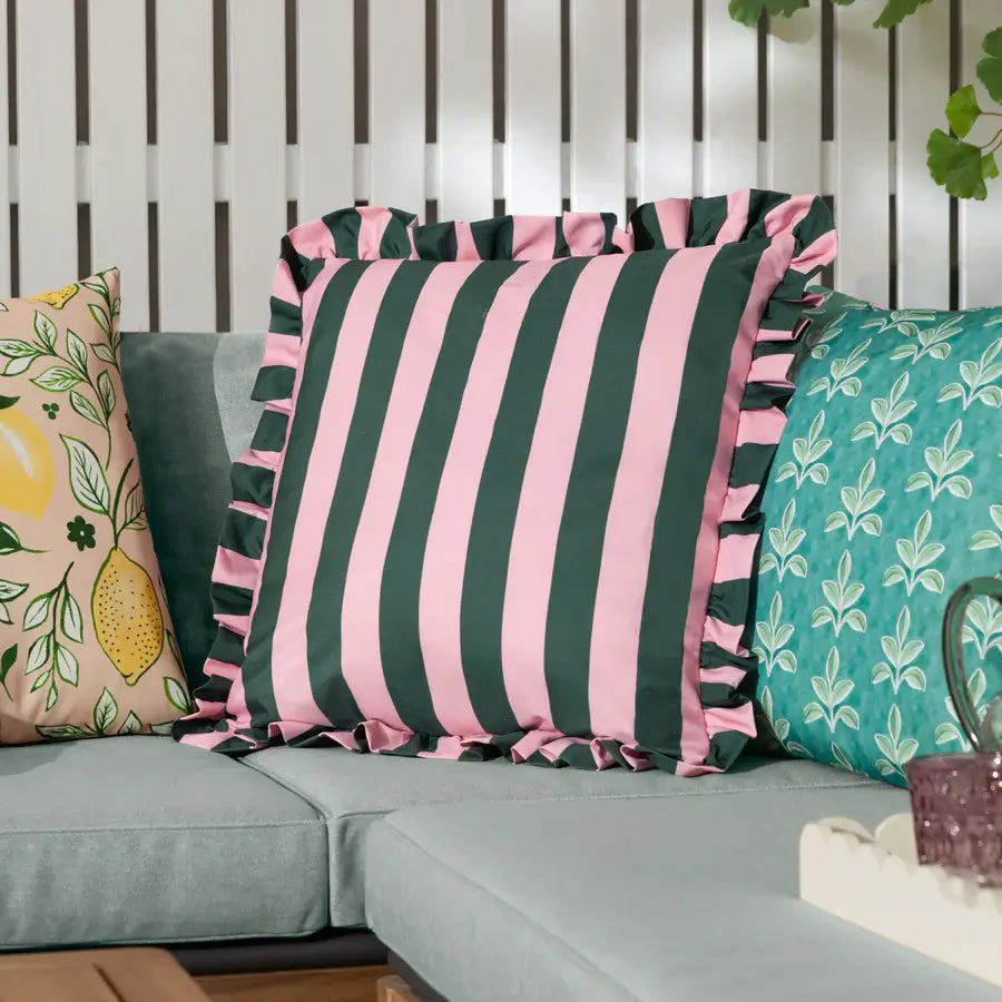 Baby pink and dark green thick striped outdoor double sided cushion with thick ruffled matching edge, fully water resistant. Available at Albury House Interiors.