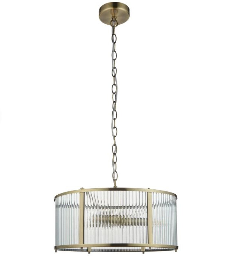 Chandelier with brass finish and clear, ribbed, glass shade hung on a metal chain, on a white background