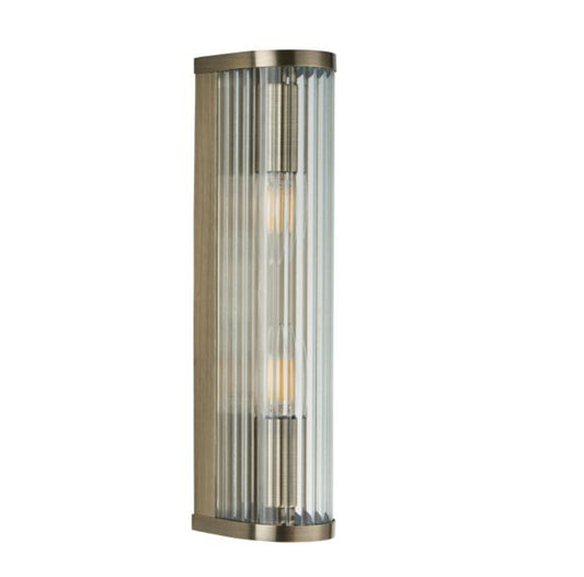 Tall cylindrical wall light fixture with ribbed glass and brass fixtures. Available to purchase from Albury House Interiors. 