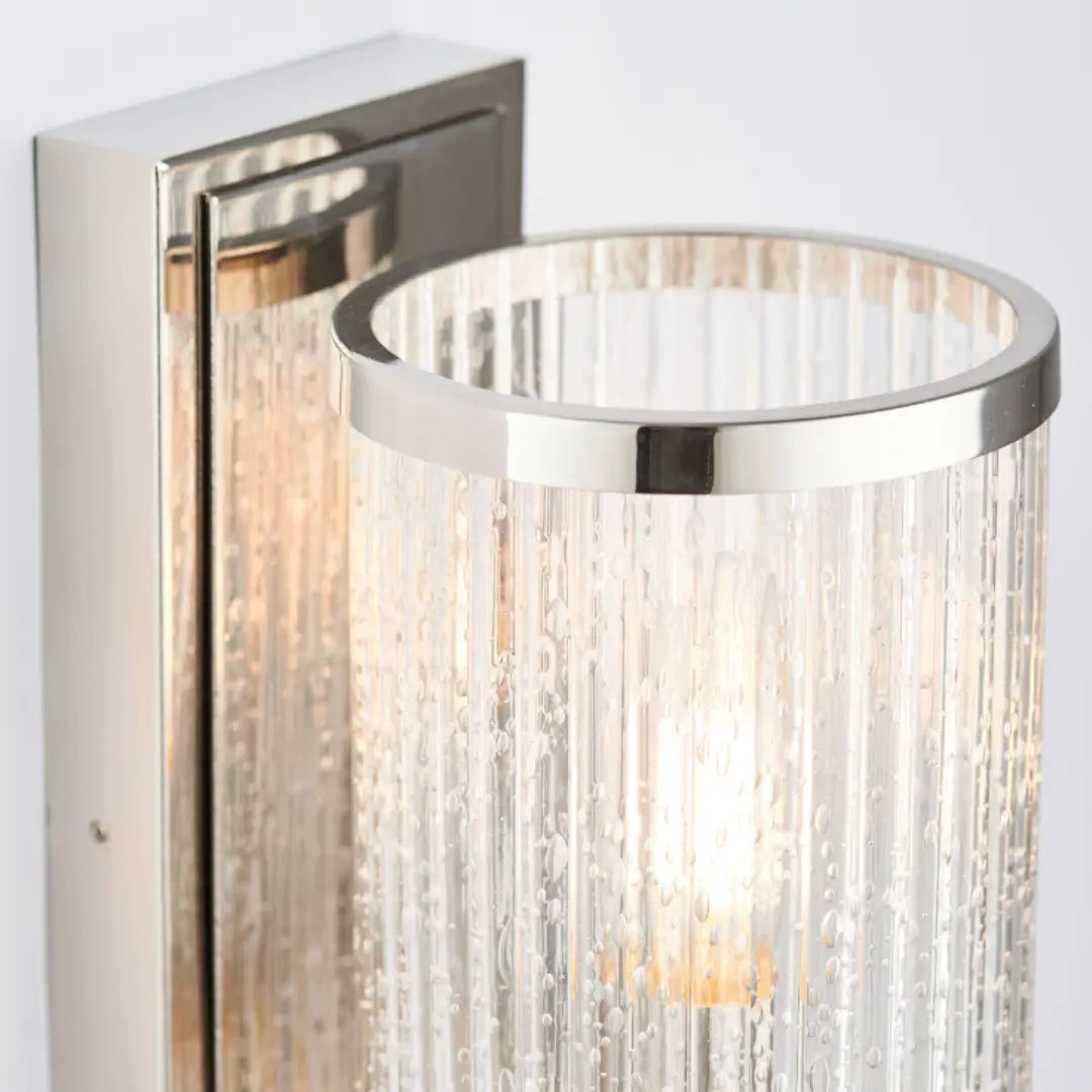 Bright nickel plated wall light, featuring  ribbed glass with a bubble effect throughout - creating a beautiful diffused light. Available to purchase from Albury House Interiors, homewares in the UK.