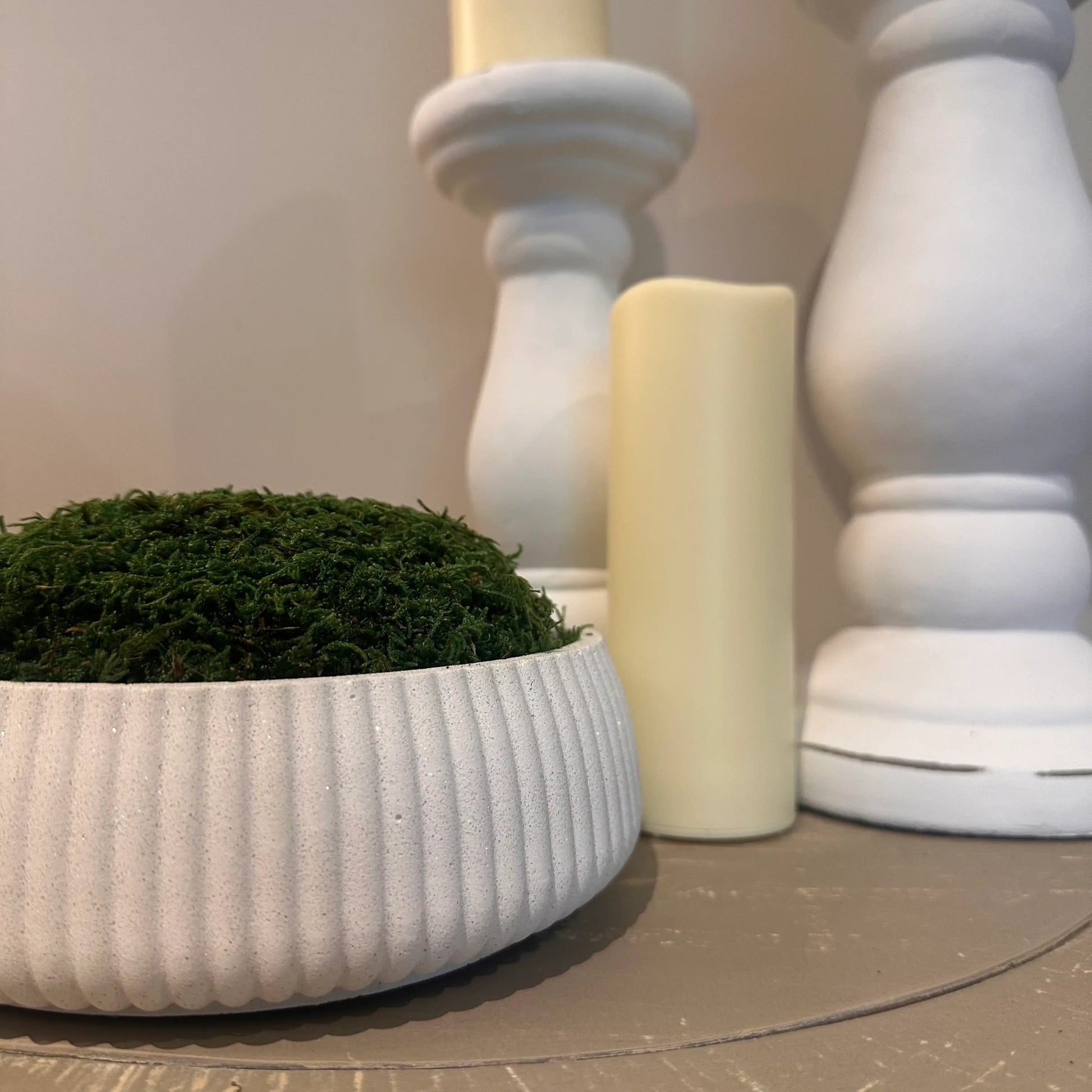 Ribbed white mineral jesmonite stone preserved green moss bowl, used by interior designers, available to purchase at Albury House Interiors.