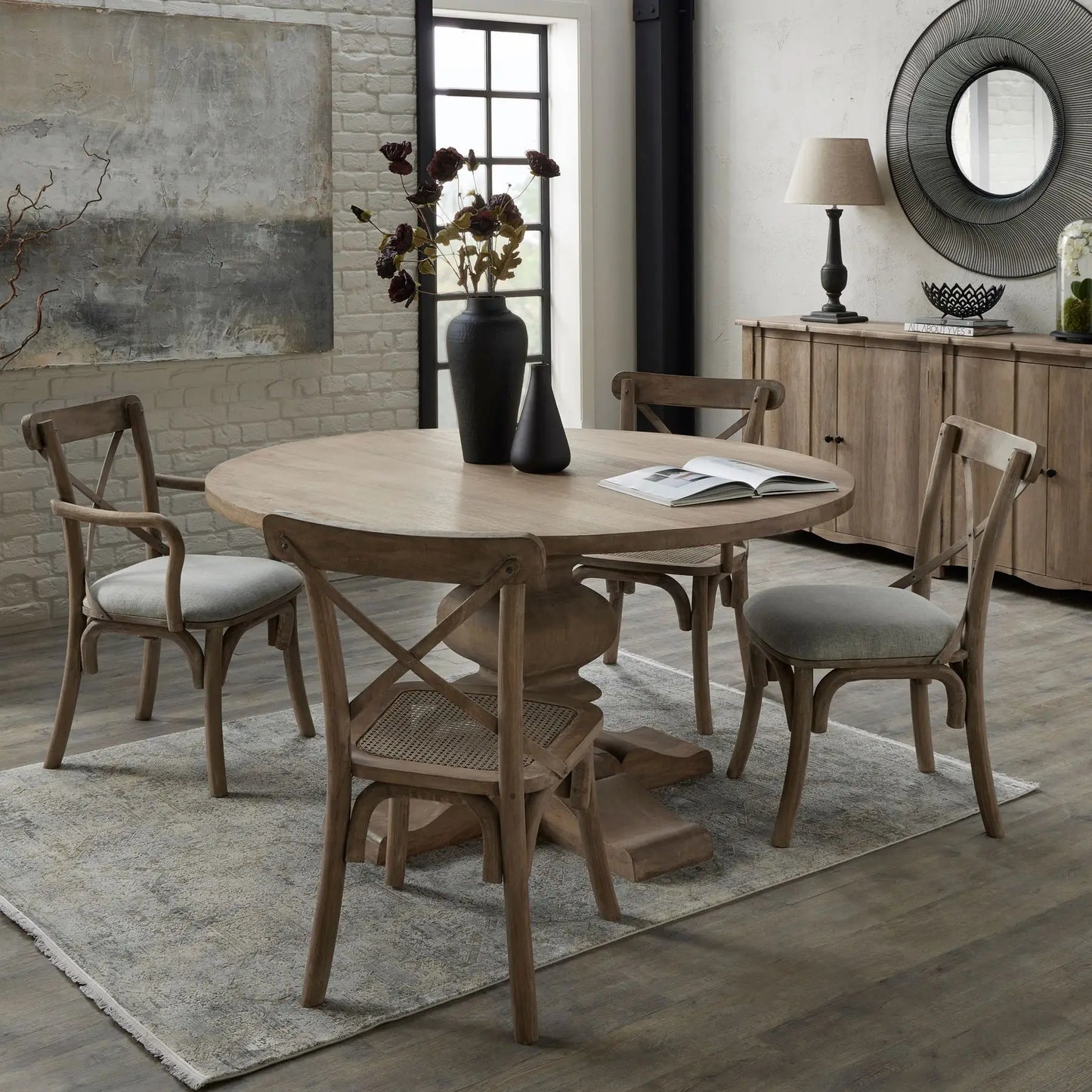 Wardour round solid wood dining table with intricate detail base and four matching wooden dining chairs. Available to purchase at Albury House Interiors.