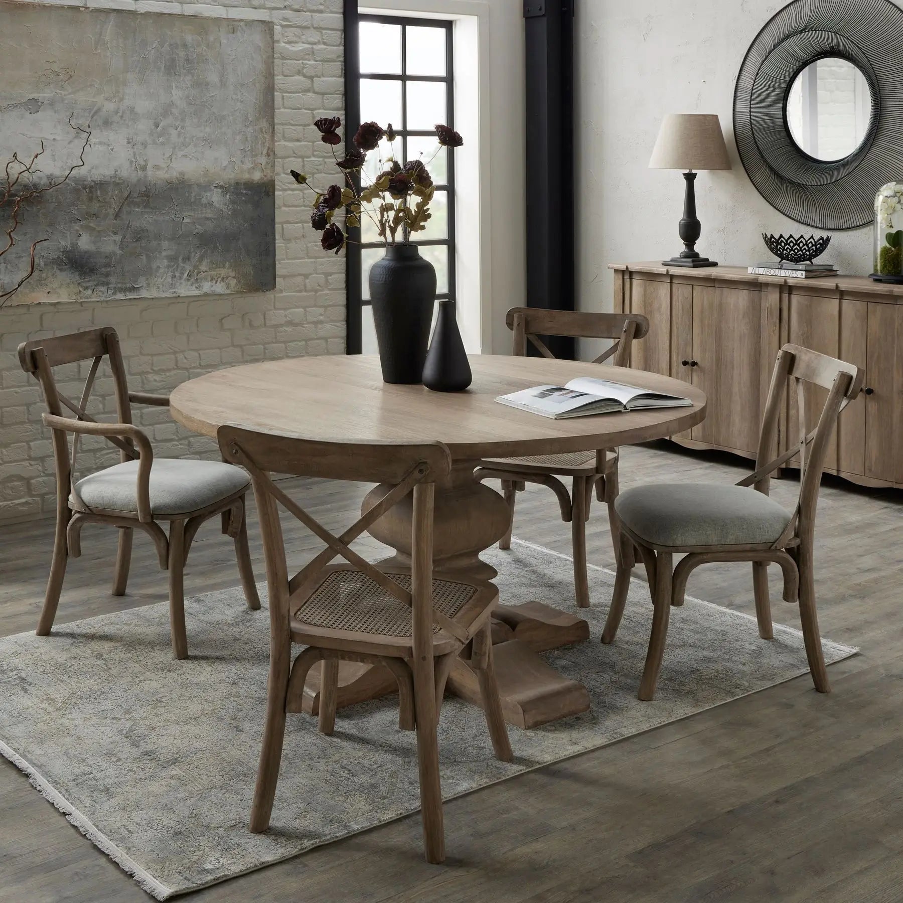 Wardour round solid wood dining table with intricate detail base and four matching wooden dining chairs. Available to purchase at Albury House Interiors.