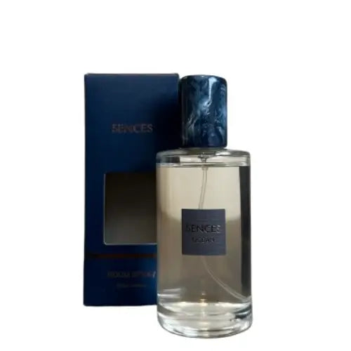 Glass bottle of Sences Ocean room spray with a dark blue marbled cap stands next to its blue packaging box. Perfect for giving. Available to purchase from Albury House Interiors.