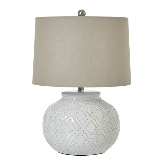 white-ceramic-dimple-lamp-with-diamond-patterns-and-neutral-linen-shade-at-albury-house-interiors 