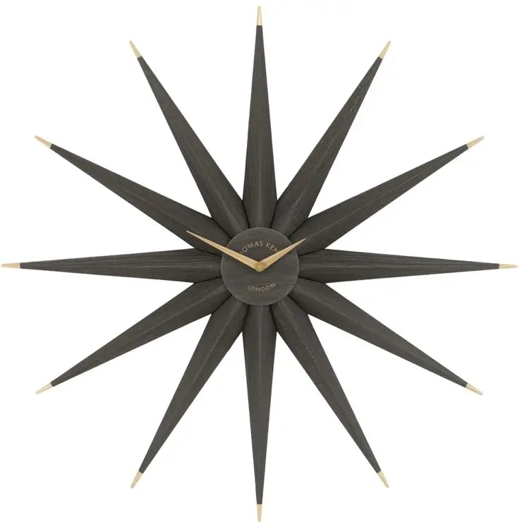 Starburst statement wall clock in North Star shape crafted from wood and finished in a dark warm grey, with gold accents and matching clock hands. Available to purchase from Albury House Interiors, home decor and accessories shop in Essex. 